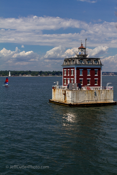 New London Ledge Light with a sailboat and New London Harbor Light in the background.
